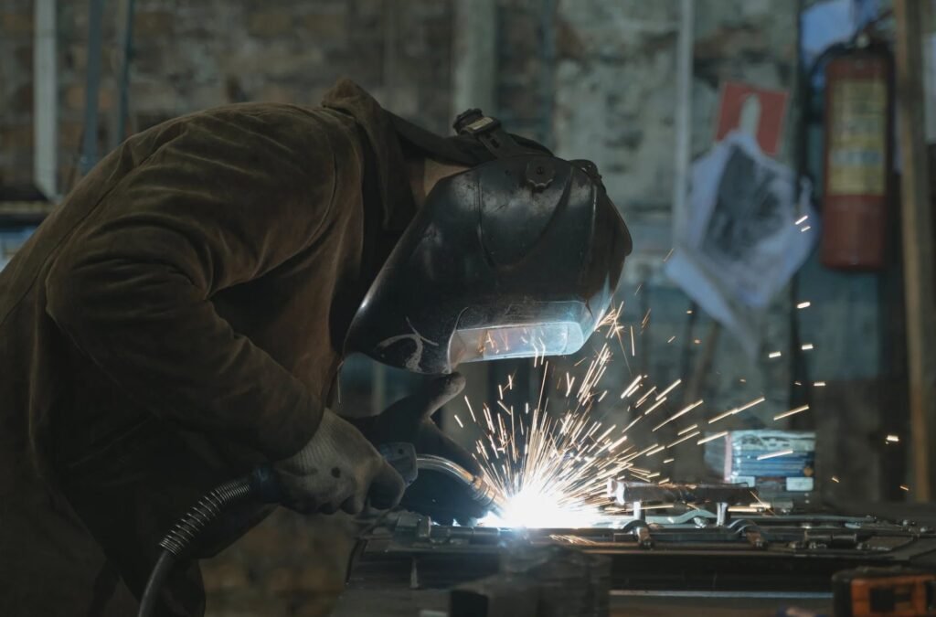 A Man Wearing Safety Helmet Doing Welding.